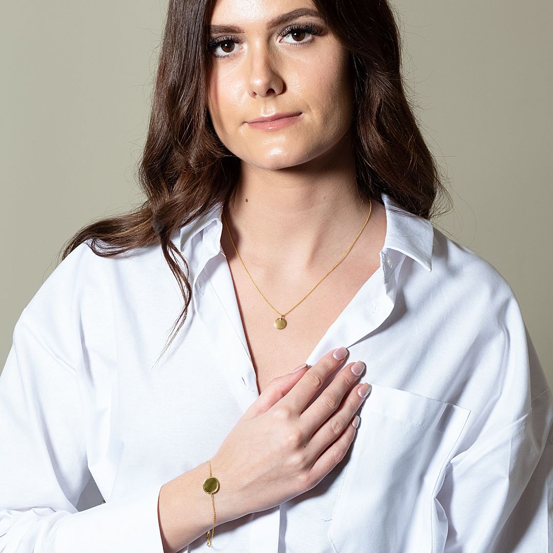 9ct gold disc bracelet and pendant shown on model