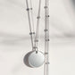 Silver disc pendant on a satellite chain