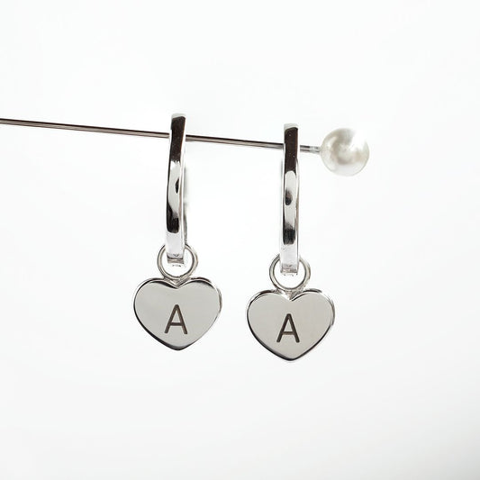 Silver huggie earrings with heart charm engraved with letter A