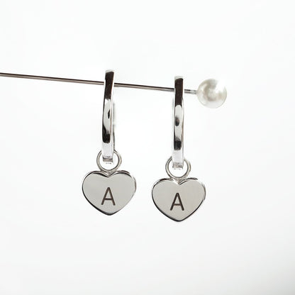 Silver huggie earrings with heart charm engraved with letter A